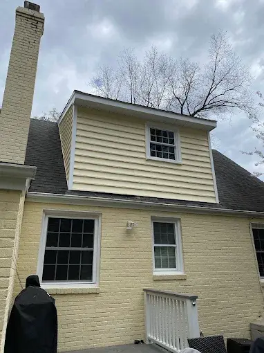 Second floor room expanded, broken down to studs, viewing from backyard looking at the roof